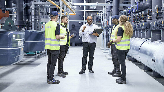 Leadec team talking at thermal power station.